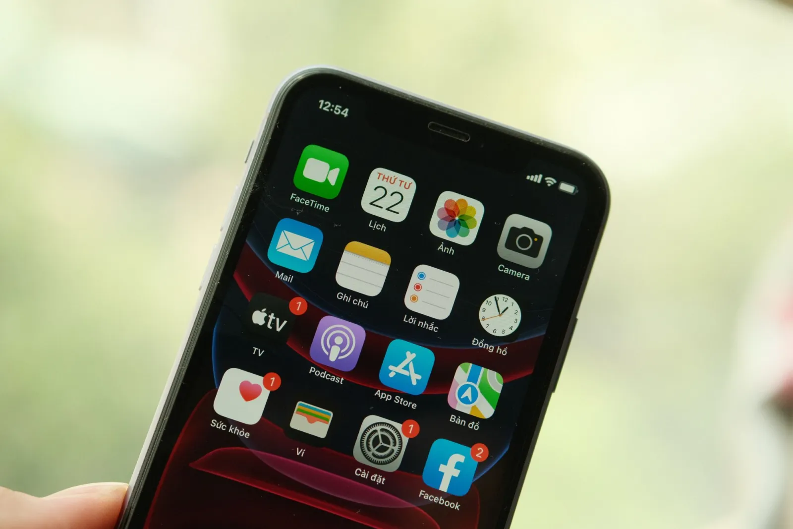 Close-up of an iPhone home screen with the Photos app